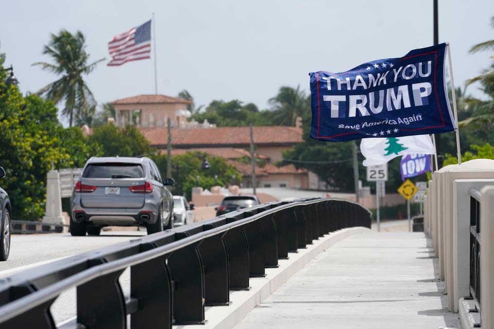 A flag flies in the air near former President Donald Trump's Mar-a-Lago estate, Tuesday, Aug. 9, 2022, in Palm Beach, Fla. The FBI searched Trump's Mar-a-Lago estate as part of an investigation into whether he took classified records from the White House to his Florida residence, people familiar with the matter said Monday.