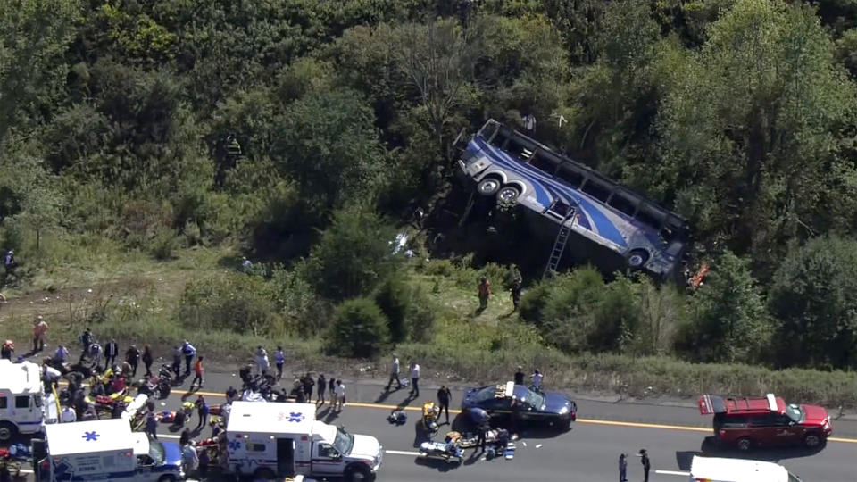 Emergency responders work the scene of a fatal bus crash, in Wawayanda, N.Y., Thursday, Sept. 21, 2023. The charter bus carrying high school students to a band camp hurtled off a New York highway and down an embankment, officials said. (NBC New York via AP)