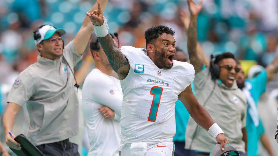 The Miami Dolphins sideline, including Tua Tagovailoa, react after a touchdown by wide receiver Robbie Chosen (not pictured) against the Denver Broncos. - Nathan Ray Seebeck/USA Today Sports/Reuters