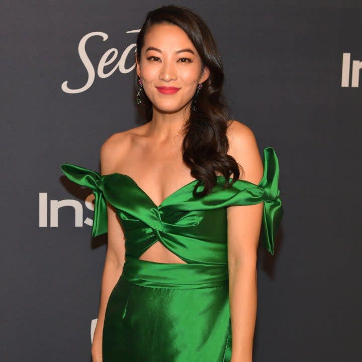 Arden in an off-the-shoulder silk cutout gown