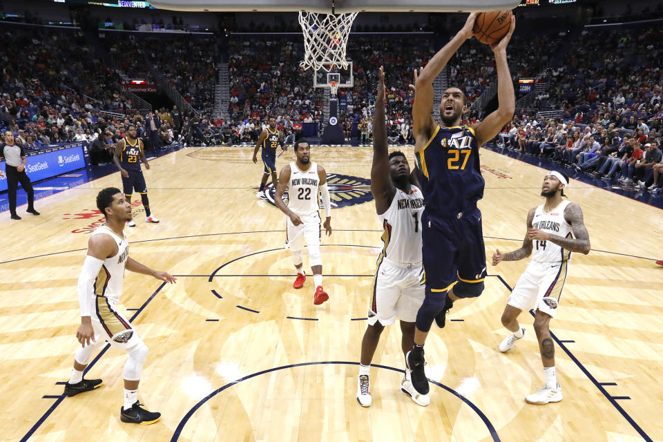 Utah Jazz center Rudy Gobert (27) shoots over New Orleans Pelicans forward Zion Williamson (1) during the second half of a preseason NBA basketball game in New Orleans, Friday, Oct. 11, 2019. (AP Photo/Tyler Kaufman)