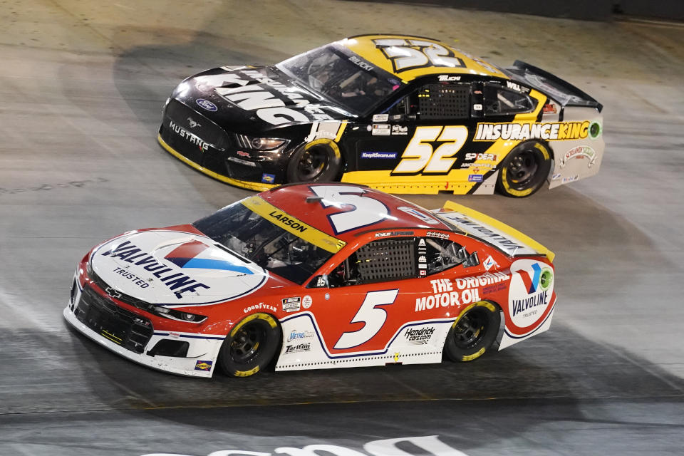 Kyle Larson (5) leads Josh Bilicki (52) through a turn during a NASCAR Cup Series auto race at Bristol Motor Speedway Saturday, Sept. 18, 2021, in Bristol, Tenn. (AP Photo/Mark Humphrey)