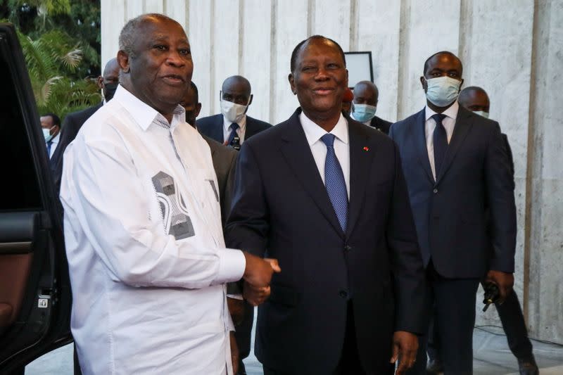 Ivory Coast's President Alassane Ouattara meets former President Laurent Gbagbo during a meeting at the presidential palace in Abidjan