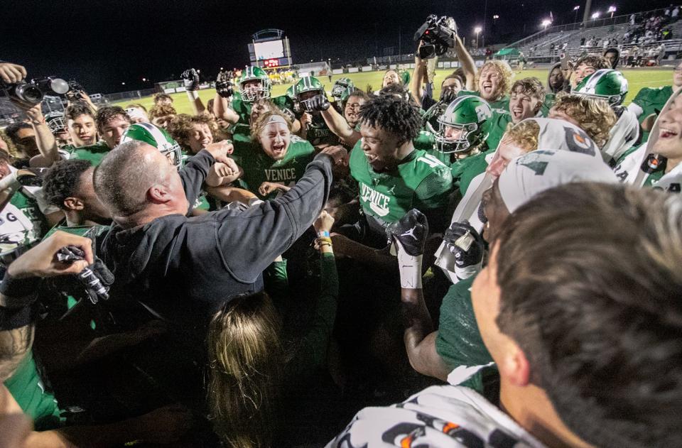 Venice High head coach John Peacock celebrates with his team as they advance to the state championship after defeating the DeLand Bulldogs 51-21 at Powell-Davis Stadium in Venice on Friday. The Indians will face Lakeland on Saturday, Dec. 9 at 8 p.m. MATT HOUSTON/HERALD-TRIBUNE