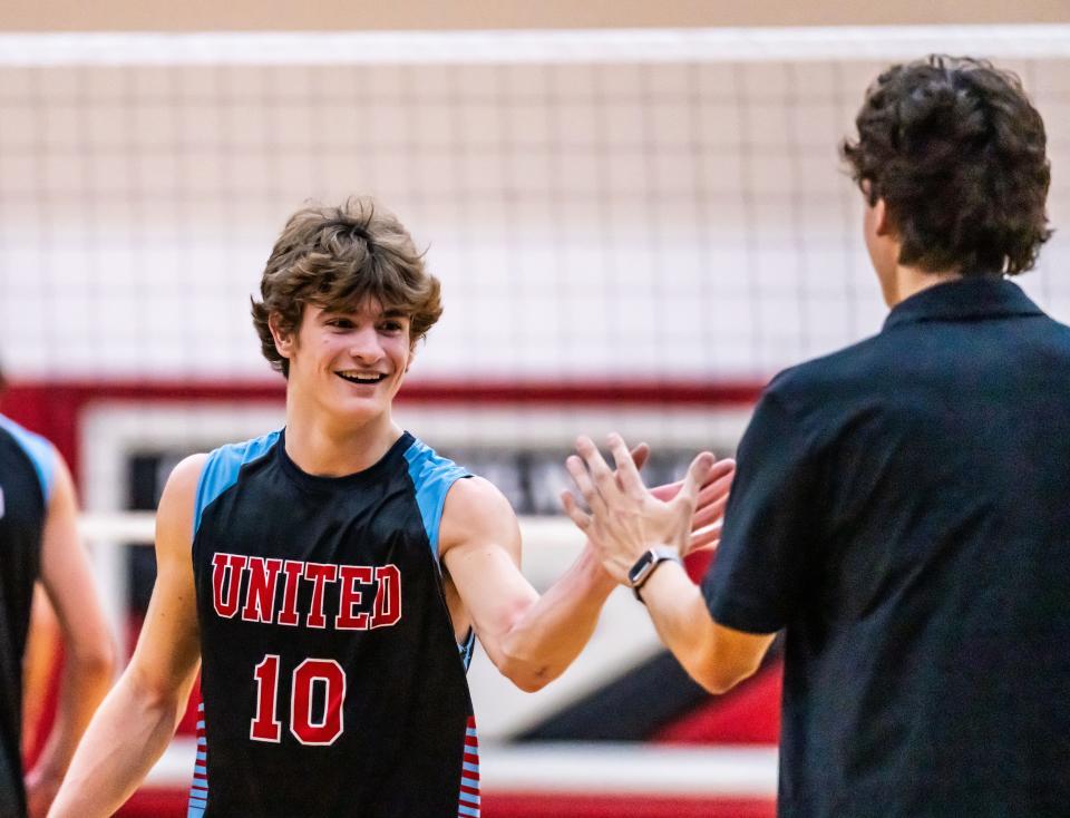 South Milwaukee United's Ethan Jetzer celebrates a point with coach Tyler Cicigoi during the match at home against New Berlin United.