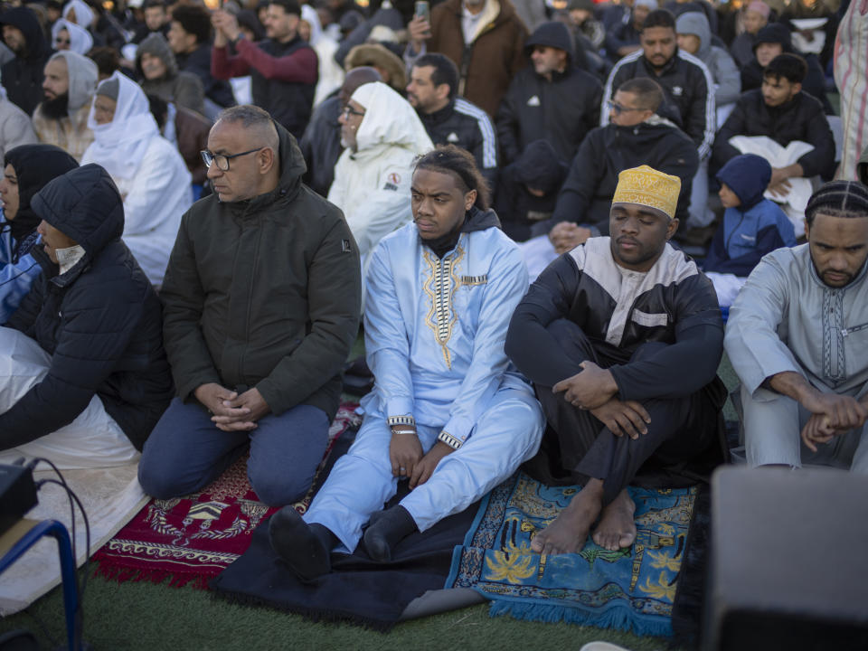 Muslim worshippers offer Eid al-Fitr prayers marking the end of the holy fasting month of Ramadan at the Malpasse soccer stadium in Marseille, southern France, Wednesday, April 10, 2024. (AP Photo/Daniel Cole)