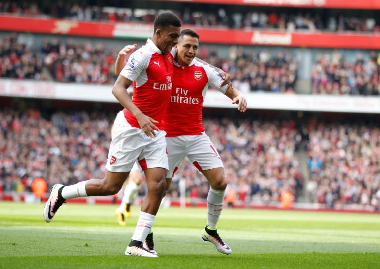 Arsenal's Chilean striker Alexis Sanchez (R) celebrates with Arsenal's Nigerian striker Alex Iwobi after scoring during the English Premier League football match against Watford at the Emirates Stadium in London on April 2, 2016