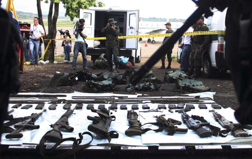 Policemen display rifles, mortars and grenade launchers seized from FARC guerrillas, in Cucuta