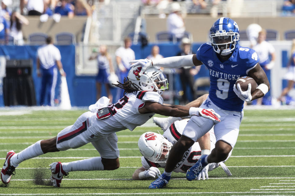 Kentucky wide receiver Tayvion Robinson (9) stiff arms Ball State defensive back Thailand Baldwin (12) during the second half of an NCAA college football game in Lexington, Ky., Saturday, Sept. 2, 2023. (AP Photo/Michelle Haas Hutchins)