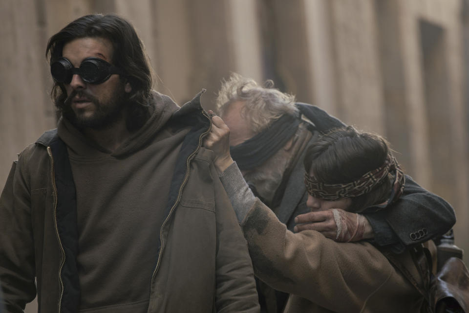 This image released by Netflix shows, from left, Mario Casas, Gonzalo de Castro, and Lola Dueñas in a scene from "Bird Box: Barcelona." (Andrea Resmini/Netflix via AP)