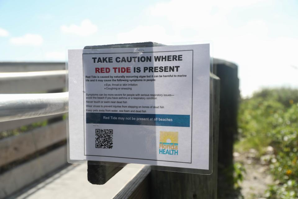 A sign warns about Red Tide 