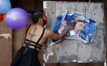 <p>A member of LGBT (Lesbians Gay Bisexual and Transgender) community deface a portrait of U.S. President Donald Trump in protest his upcoming visit, Thursday, Nov. 9, 2017, at the University of the Philippines campus in Los Banos, Laguna province south of Manila, Philippines. (Photo: Bullit Marquez/AP) </p>