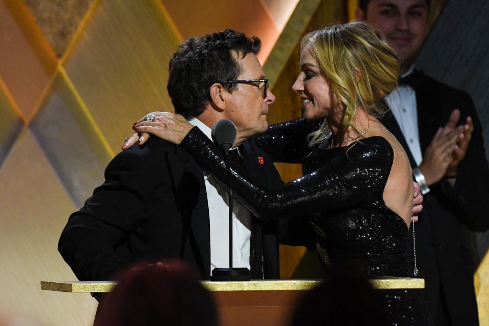 Michael J. Fox embraces his wife, Tracy Pollan, as he accepts the Jean Hersholt Humanitarian Award during the Academy of Motion Picture Arts and Sciences' 13th Governors Awards.