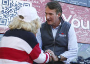 Republican gubernatorial candidate Glenn Youngkin meets with supporters after a rally at the Brambleton Center in Roanoke County on Wednesday, Oct. 27, 2021. He talks with Evelyn Hale, 80, of Roanoke. Hale said she really liked what Youngkin had to say at the rally and wanted to come out to support him. (Heather Rousseau/The Roanoke Times via AP)