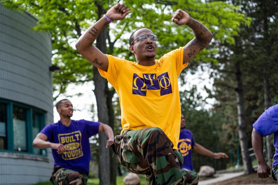 Omega Psi Phi Fraternity, Inc. members rehearse before performing on stage during the annual Young Gifted and College Bound communitywide graduation and college send-off ceremony at the Aretha Franklin Amphitheatre in Detroit on May 25, 2022. More than $15,000 in scholarship funding was awarded to college-bound metro Detroit students, giving those selected for their academics $500 each.