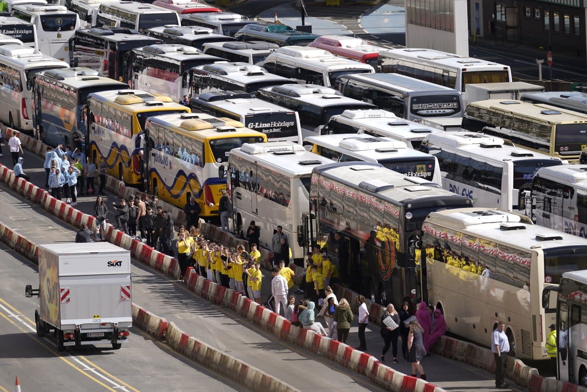 Coaches wait to enter the Port of Dover in Kent after extra sailings were run overnight to try and clear the backlog (PA)