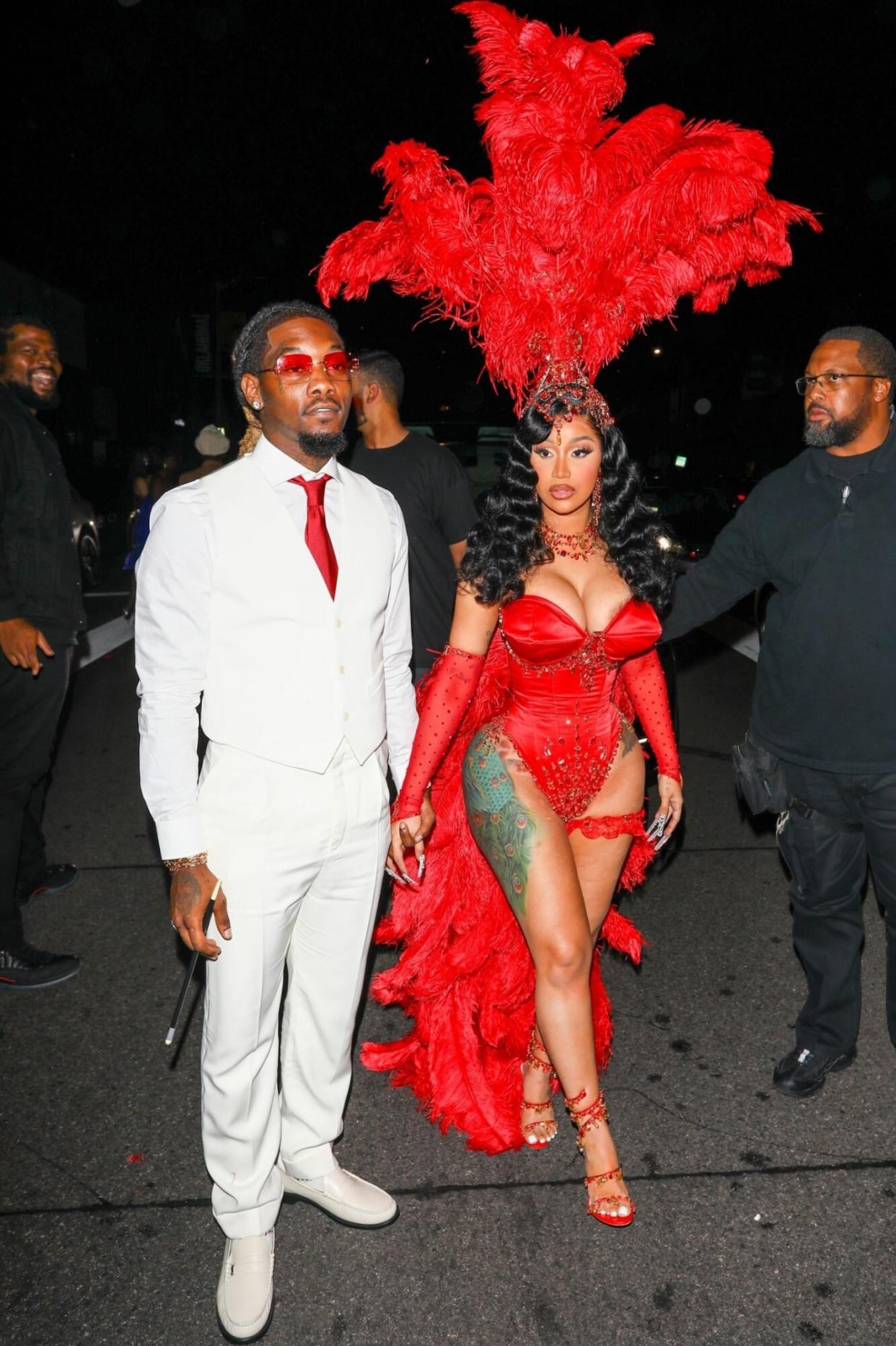 Birthday girl Cardi B & Offset are hard to miss in their matching red ensembles while attending Cardi's 30th birthday party at Poppy