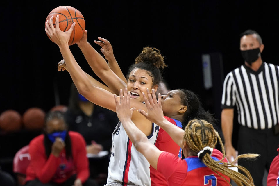 Connecticut's Olivia Nelson-Ododa is pressured by DePaul's Deja Church (3) and Darrione Rogers during the first half of an NCAA college basketball game Sunday, Jan. 31, 2021, in Chicago. (AP Photo/Charles Rex Arbogast)