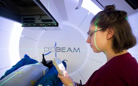 A radiographer with a test dummy as she demonstrates the NHS's new Proton Beam therapy centre  - Credit: PA