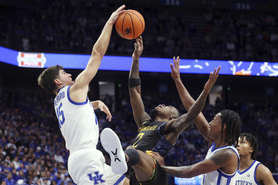 Texas A&M-Commerce's Kalen Williams has his shot blocked by Kentucky's Reed Sheppard, left, during the second half of an NCAA college basketball game in Lexington, Ky., Friday, Nov. 10, 2023. (AP Photo/James Crisp)