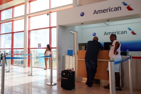 People stand at the American Airlines office at the Jose Marti International Airport in Havana