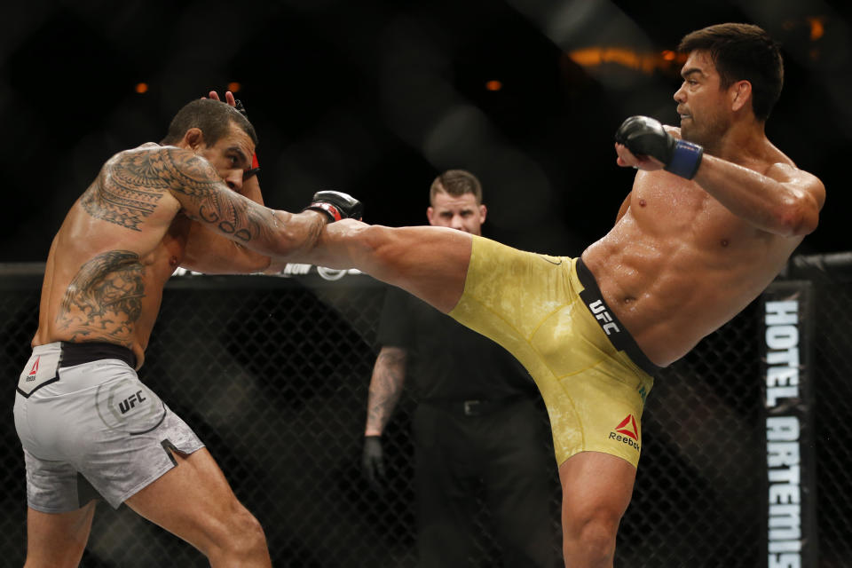 Vitor Belfort, left, announced his retirement on Saturday after taking a vicious knockout blow from fellow Brazilian Lyoto Machida in Rio de Janiero. (AP)