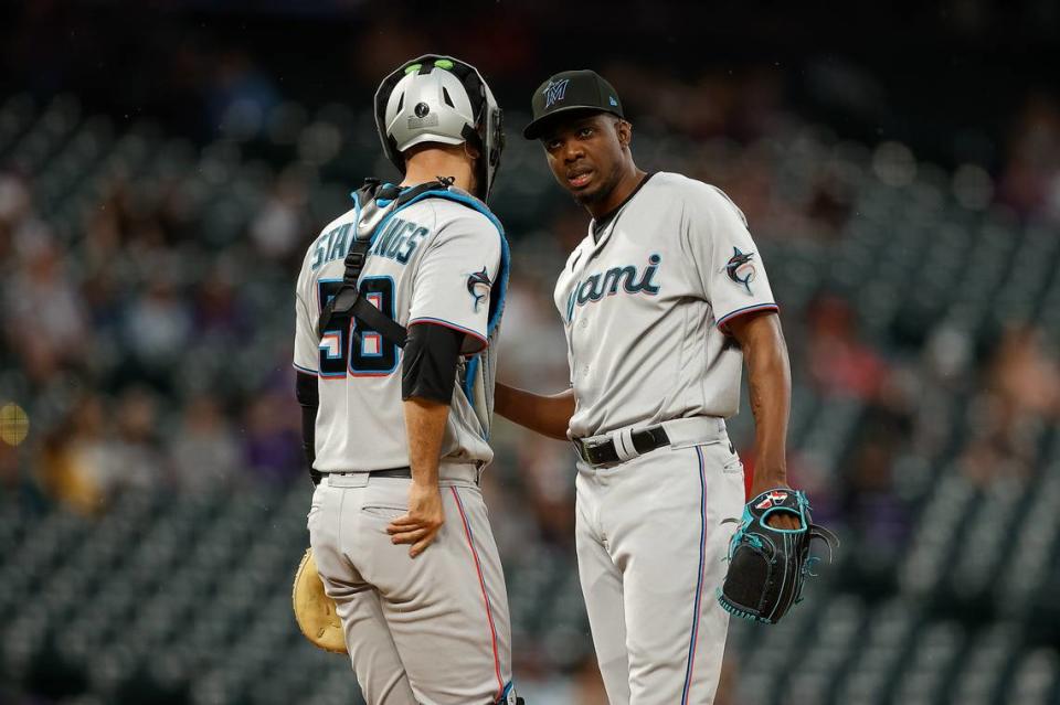 Miami Marlins relief pitcher Huascar Brazoban (31) talks with catcher Jacob Stallings (58) in the ninth inning against the Colorado Rockies at Coors Field on Thursday, May 25, 2023.