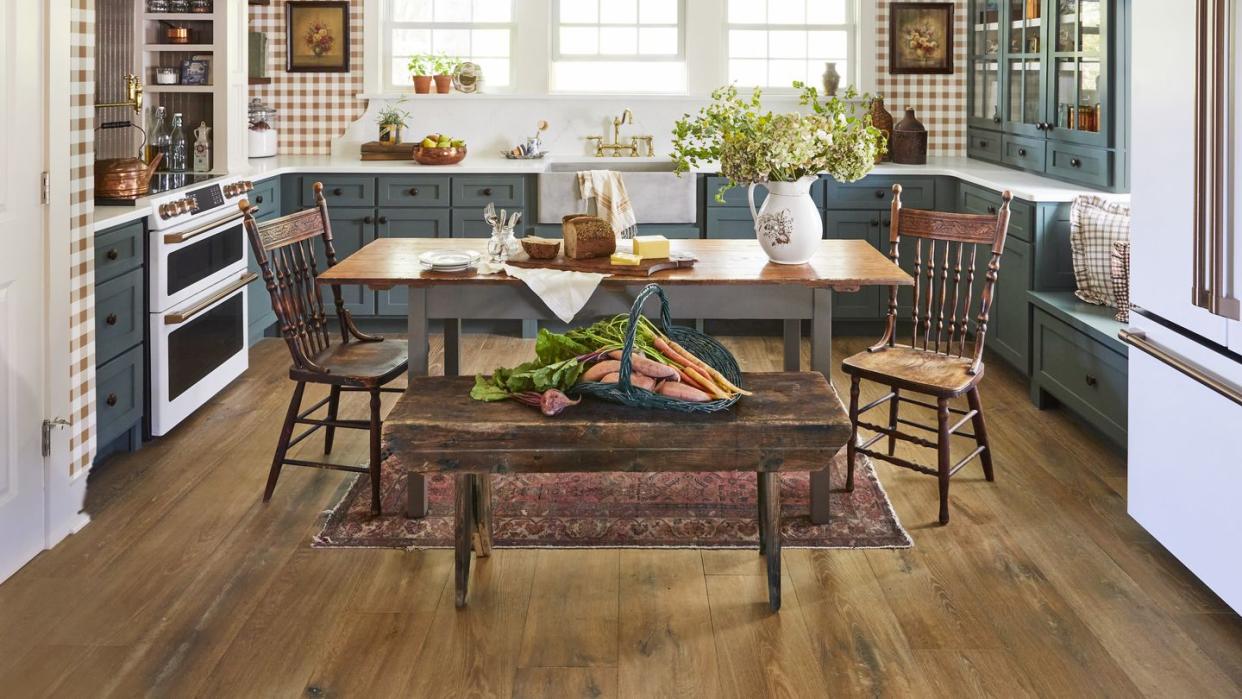 farmhouse kitchen of north carolina homeowner ronnie thompson with green cabinets and gingham wallpaper