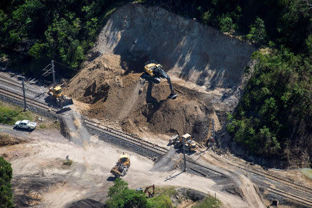 Workmen repair a section of the Goonyella rail system, that services coal mines in the Bowen Bason, after a landslide damaged the tracks as a result of heavy rain associated with Cyclone Debbie, at a section called Black Mountain located near the Queensland town of Mackay in Australia, April 11, 2017. REUTERS/Daryl Wright