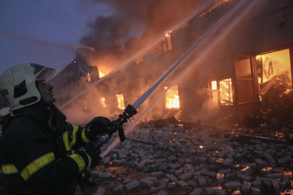 Ukrainian firefighters extinguish a blaze at a warehouse after a bombing on the outskirts of Kyiv, Ukraine, Thursday, March 17, 2022. Russian forces destroyed a theater in Mariupol where hundreds of people were sheltering Wednesday and rained fire on other cities, Ukrainian authorities said, even as the two sides projected optimism over efforts to negotiate an end to the fighting. (AP Photo/Vadim Ghirda)