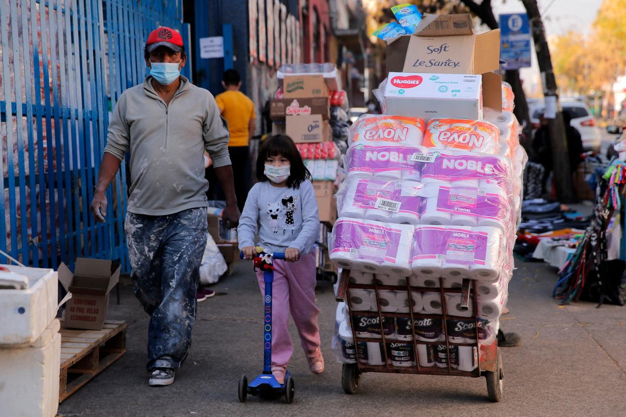 People walk at a commercial area of the Quinta normal commune in Santiago, on June 10, 2021. Chilean authorities have imposed  a new total lockdown in the Santiago metropolitan region due to an increase in coronavirus cases, despite around 58 per cent of the population being already vaccinated.  (AFP via Getty Images)