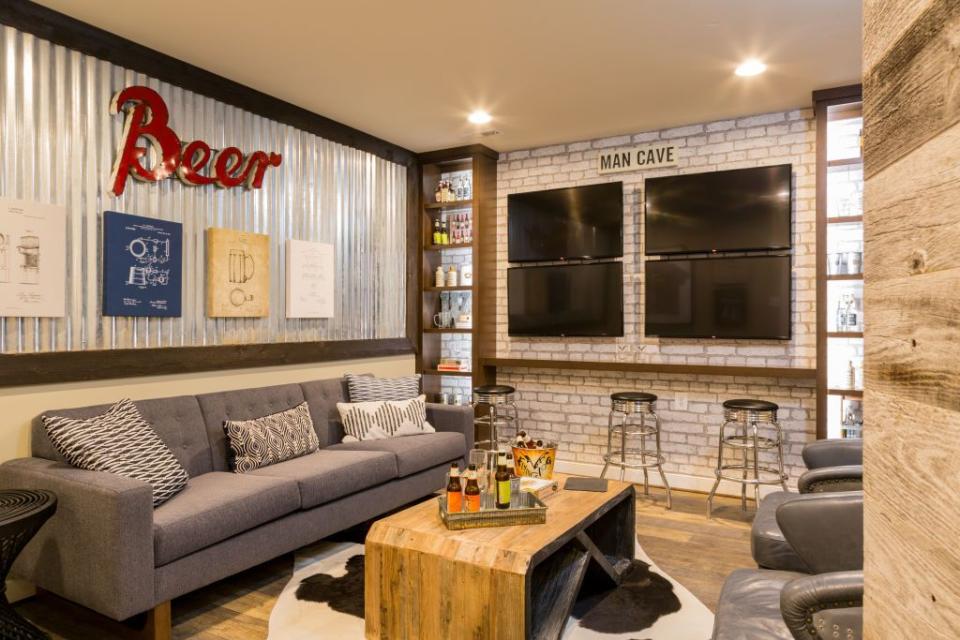 <p>Comfy seating + a bar setup + screens for every game = the perfect basement sports den.</p>