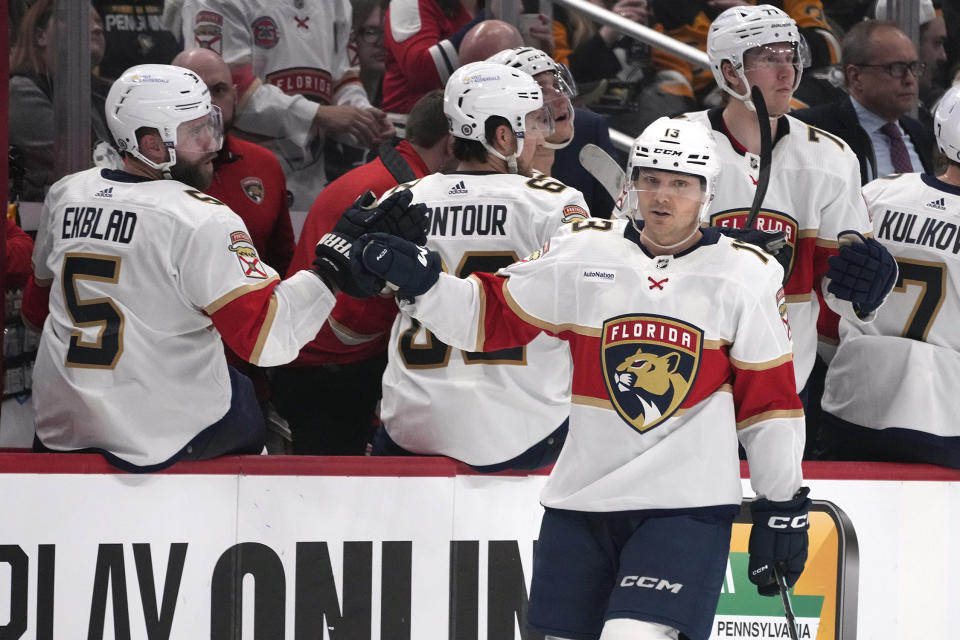 Florida Panthers' Sam Reinhart (13) returns to the bench after scoring against the Pittsburgh Penguins during the second period of an NHL hockey game in Pittsburgh, Friday, Jan. 26, 2024. (AP Photo/Gene J. Puskar)