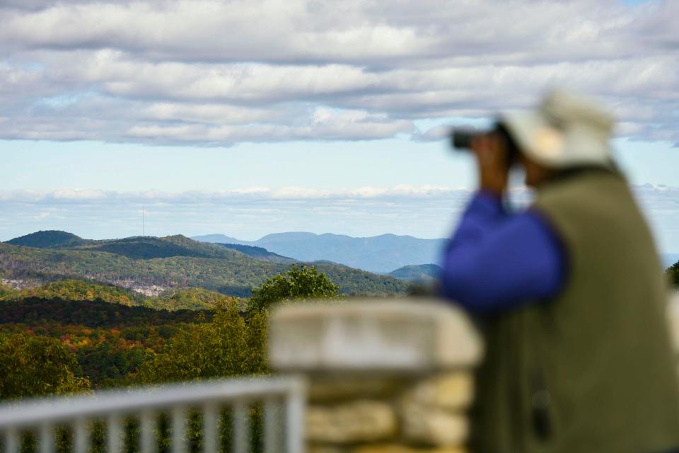 Ed Moorer, of Easley, volunteer for Hawk Migration Association of America, tracks hawks at the end of the yearly hawk migration as leaves begin to change in the Blue Ridge Mountains seen from Sassafras Mountain on Tuesday, Oct. 23, 2023.