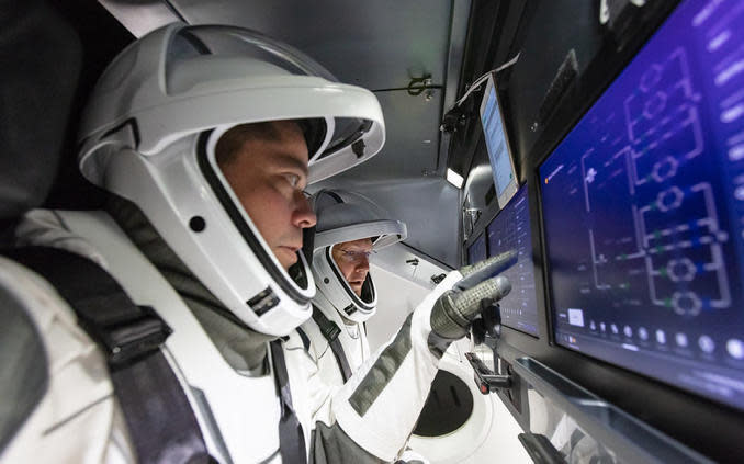 Behnken, left, and Hurley rehearse procedures in a Crew Dragon flight simulator at SpaceX's Hawthorne, California, rocket factory. / Credit: SpaceX