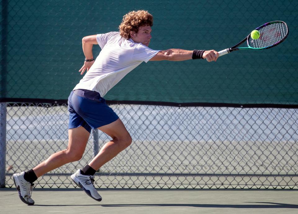 Winter Haven's Ben Saltman reaches for a backhand in his No. 1 singles final against George Jenkins' Nico Kumria on Wednesday at the Class 4A, District 6 boys tennis tournament at George Jenkins High School.