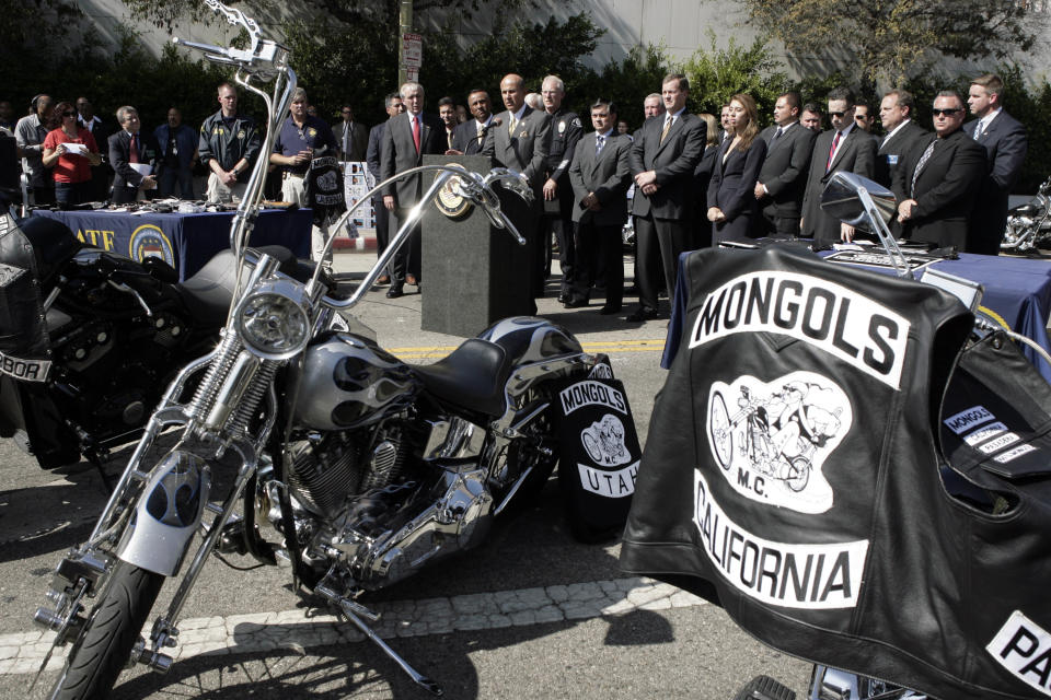 FILE - In this Oct. 21, 2008, file photo, the Mongols motorcycle club's logo adorns clothing and motorcycles at a news conference in Los Angeles. A federal judge on Friday, May 17, 2019, fined the Mongols motorcycle club $500,000 in a racketeering and conspiracy case but refused the latest effort in a decade-long attempt by the government to take away the club's control over its logo — a Genghis Khan-style rider in sunglasses astride a chopper-style bike. (AP Photo/Ric Francis, File)