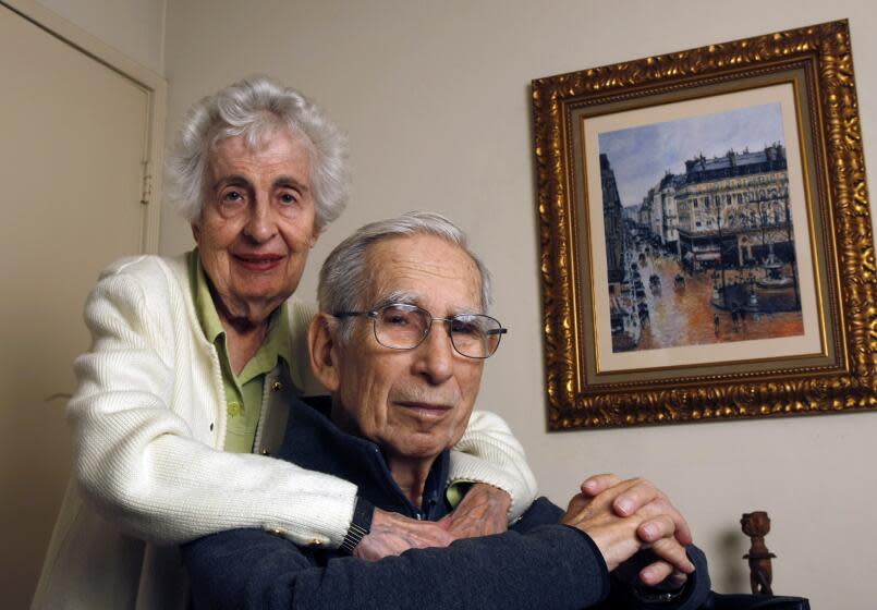 Beverly Cassirer and her husband Claude Cassier at their home in San Diego. A copy of the painting they wanted return hangs behind them.