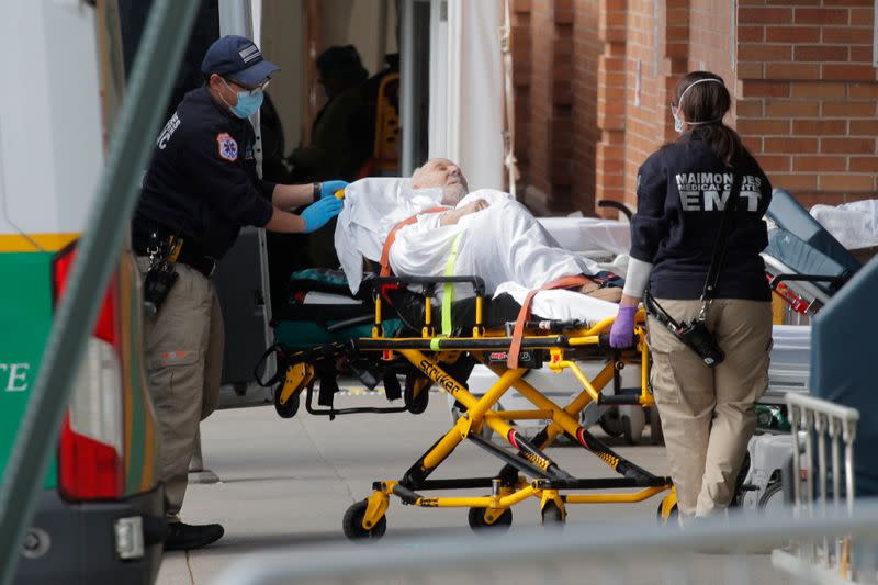 Paramedics take a patient into emergency center at Maimonides Medical Center during outbreak of coronavirus disease (COVID-19) in Brooklyn New York