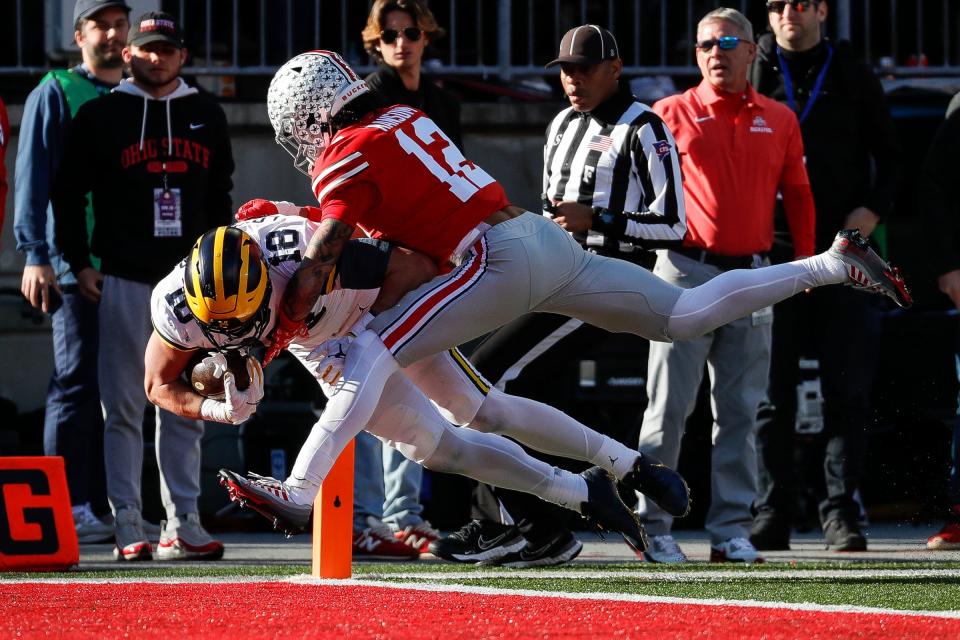 Michigan tight end Colston Loveland scores a touchdown against Ohio State safety Lathan Ransom during the second half at Ohio Stadium in Columbus, Ohio, on Saturday, Nov. 26, 2022.