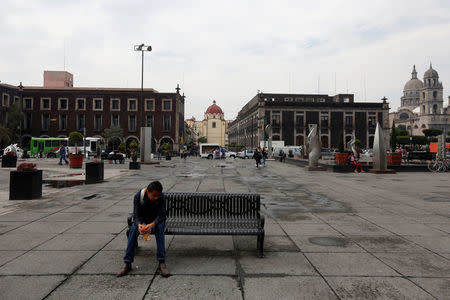 A man sits on a bench a day after local elections, in the main square of Toluca, Mexico June 5, 2017. REUTERS/Carlos Jasso