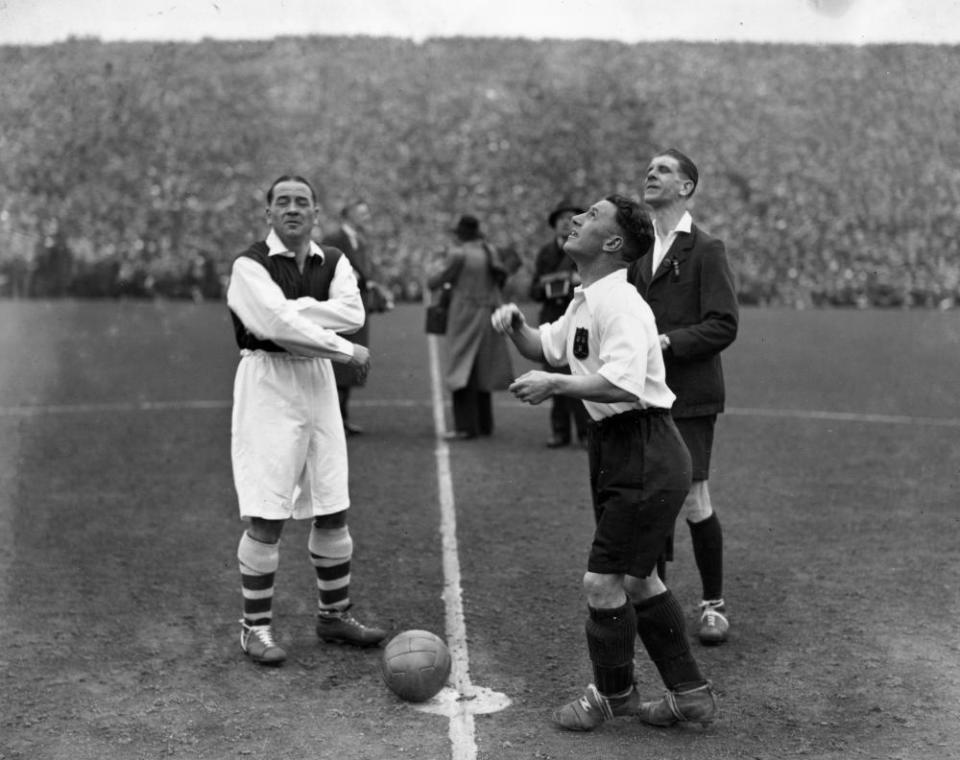 Arsenal captain Alex James watches as Grimsby's Jackie Bestall throws himself before the 1936 FA Cup semi-final.