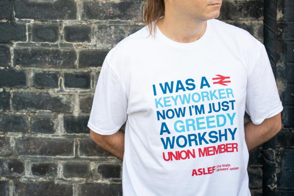 An Aslef member at a picket line at Willesden Junction station (PA) (PA Wire)