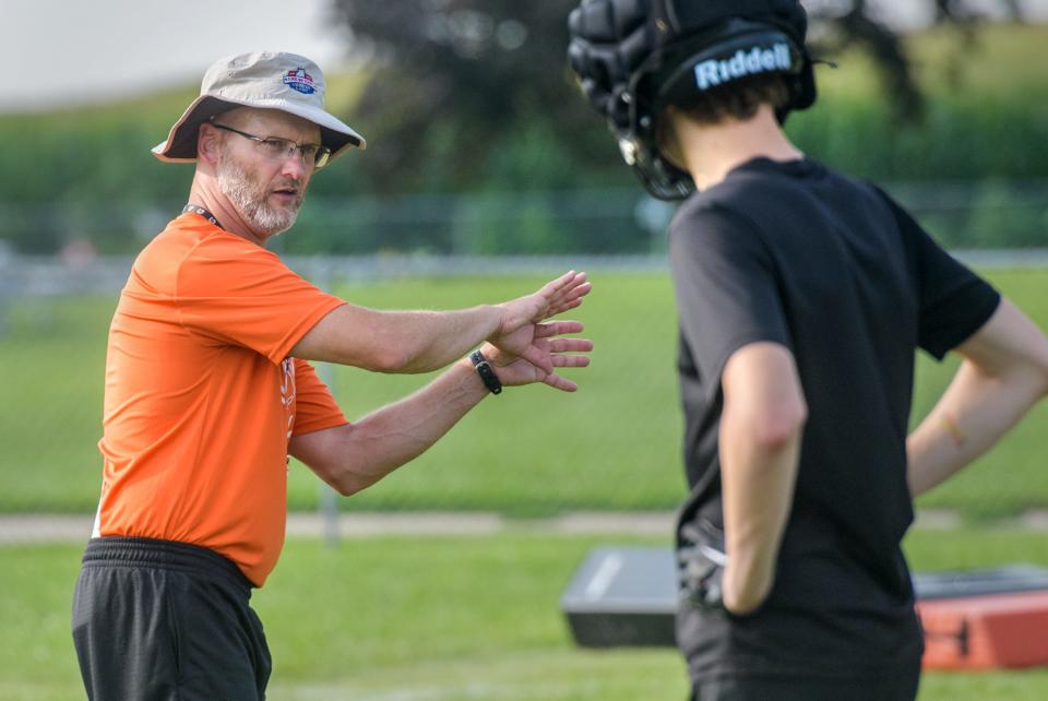 Elmwood/Brimfield head coach Todd Hollis gives some instruction during the official first day of high school football practice Monday, Aug. 7, 2023 at Elmwood High School.