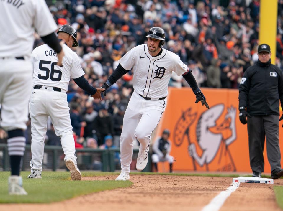 Detroit Tigers right fielder Matt Vierling celebrates his fourth-inning homer with Detroit Tigers third base coach Joey Cora as the Detroit Tigers take on the Oakland Athletics for the Detroit home opener at Comerica Park on Friday, April 5, 2024.