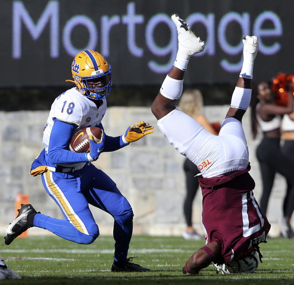 Virginia Tech safety Tae Daley (17) flips while defending Pittsburgh's Shocky Jacques-Louis (18) in the first half of an NCAA college football game, Saturday Oct. 16 2021, in Blacksburg, Va. (Matt Gentry/The Roanoke Times via AP)