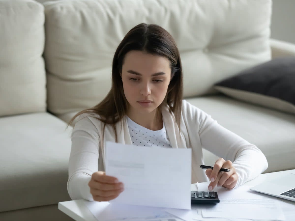 A person at home calculating their bills (Getty Images/iStockphoto)