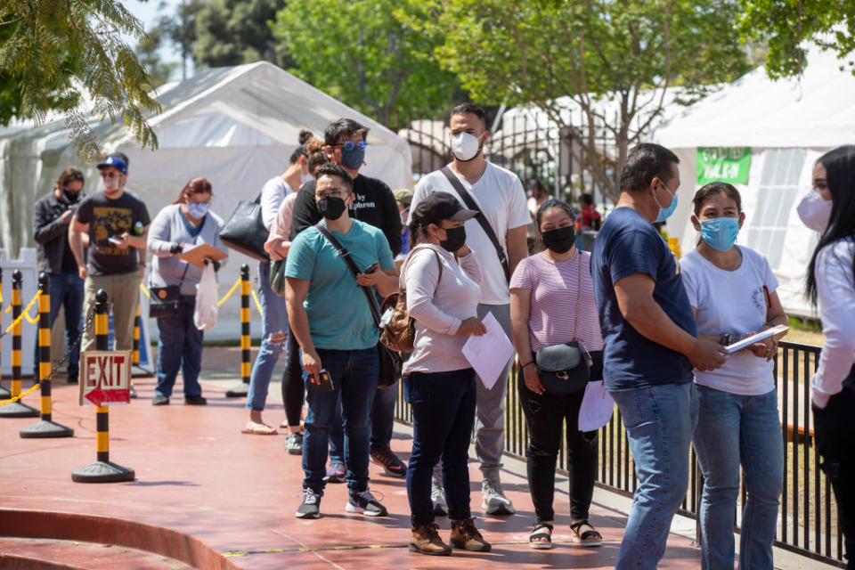 People wait in line to receive the COVID-19 Vaccination at Kedren Health on April 15, a day that vaccines were made available to all people 16+ in Los Angeles. (Allen J. Schaben / Los Angeles Times via Getty Images)