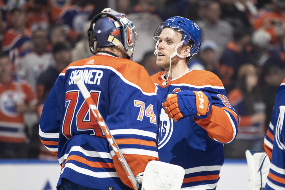 Edmonton Oilers goalie Stuart Skinner (74) and Connor McDavid (97) celebrate their win over the San Jose Sharks in NHL hockey game action in Edmonton, Alberta, Thursday April 13, 2023. (Jason Franson/The Canadian Press via AP)