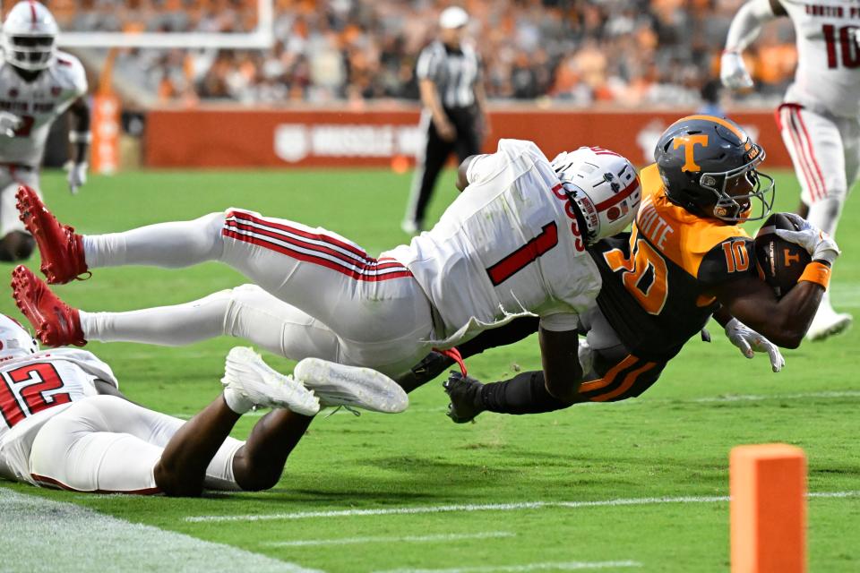 KNOXVILLE, TENNESSEE - SEPTEMBER 09: Squirrel White #10 of the Tennessee Volunteers comes up short of a touchdown after being tackled by Cedarius Doss #1 of the Austin Peay Governors in the third quarter at Neyland Stadium on September 09, 2023 in Knoxville, Tennessee.